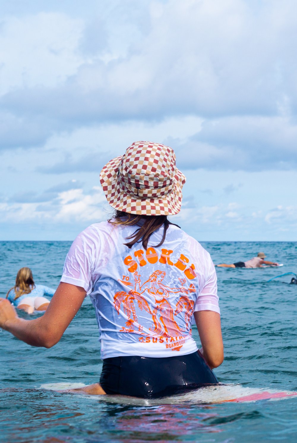 Smiling surfer in checker hat